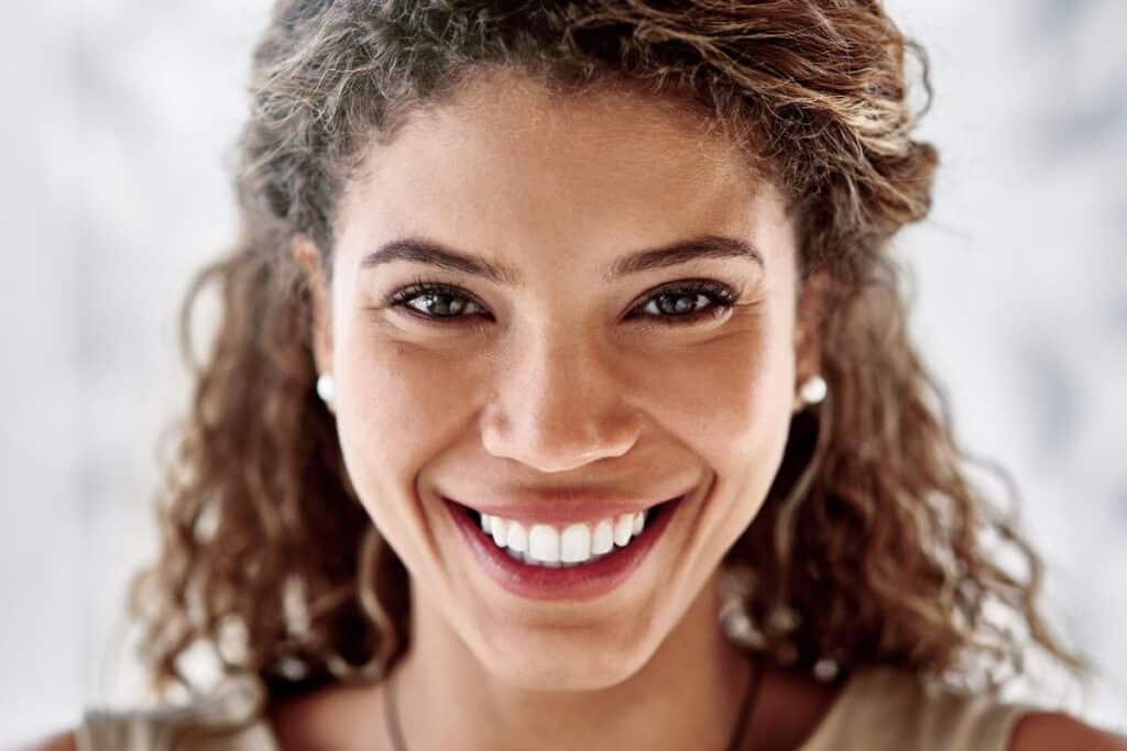 Woman with a bright, healthy smile showing white teeth and engaging expression.